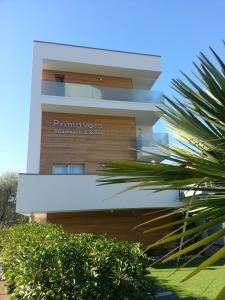 a building with a sign on the side of it at Primavera ApartmentSuites in Riva del Garda