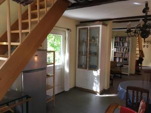 a living room with a staircase and a window at Fischer´s Häuschen in Straupitz