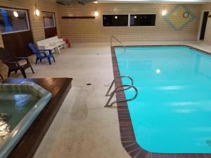 a large pool with a hot tub in a building at Heart of Frisco Condo in Frisco