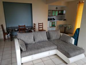 a living room with a couch and a kitchen at Marcus972 in Sainte-Luce +7 photos