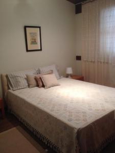 a bedroom with a large bed with pillows on it at Casa da Bia in Quarteira