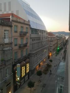 a building with a glass dome on a city street at Loft Velázquez Moreno 35 in Vigo