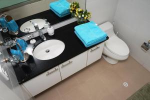 a bathroom with a sink and a toilet at Vega Apartment for Rent in Quito +19 photos