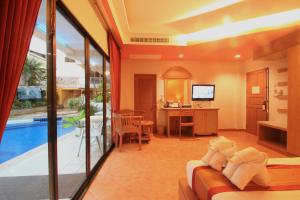 a living room with a swimming pool and a living room at Baan Boa Resort in Patong Beach