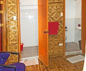 a bathroom with a door and a sink and a toilet at MJ Room Rental in Panglao +36 photos