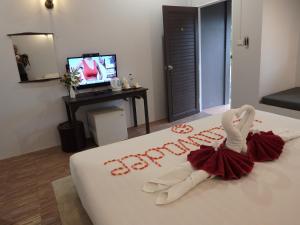 a hotel room with a swan decoration on a bed at Leelawadee Khao-lak in Khao Lak