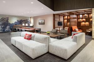 a living room with two white couches at Hyatt Place Westminster Denver in Westminster