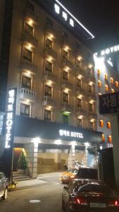 a hotel with cars parked in front of it at night at Rampart Hotel in Gwangmyeong