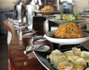 a buffet with plates of food on a table at Ocean Star Hotel in Koror