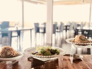 two plates of food on a wooden table at Ocean Star Hotel in Koror