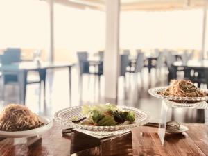 two plates of food on a wooden table at Ocean Star Hotel in Koror +53 photos
