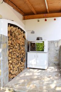 a kitchen with a stove and a stone wall at Holiday Home Vilata in Kŭrdzhali