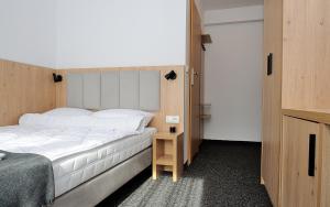 a bedroom with a large white bed and a table at Willa Centrum in Zakopane