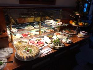 a buffet with many different types of food on display at Hotel Alter Speicher in Lübeck +6 photos