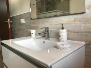 a white sink in a bathroom with a mirror at B&B Le Mansarde in Pescara
