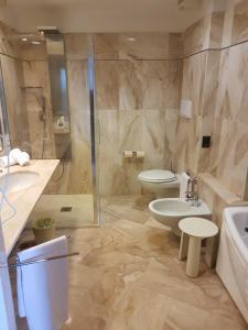 a bathroom with a toilet and a sink and a shower at Circeo Park Hotel in San Felice Circeo