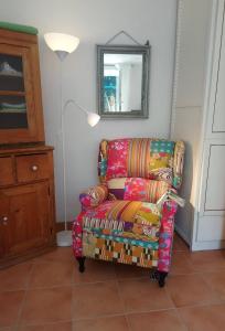 a living room with a chair and a mirror at Haus 3 Birken in Ramberg