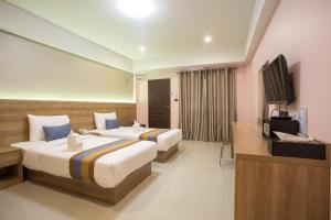Postel nebo postele na pokoji v ubytování Unity Hotel