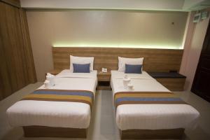 Postel nebo postele na pokoji v ubytování Unity Hotel