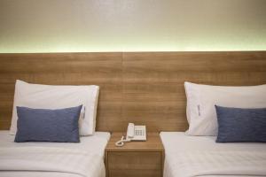 Postel nebo postele na pokoji v ubytování Unity Hotel