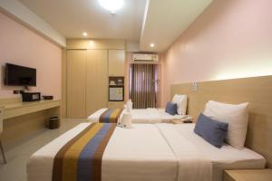 Postel nebo postele na pokoji v ubytování Unity Hotel