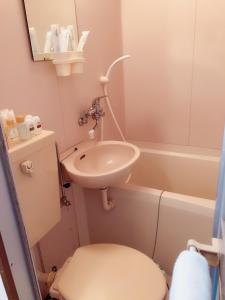 a small bathroom with a sink and a toilet at Komorebi in Uji