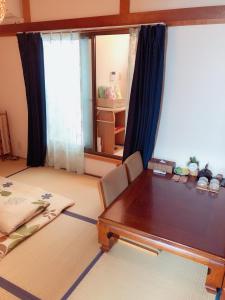 a dining room with a table and a window at Komorebi in Uji