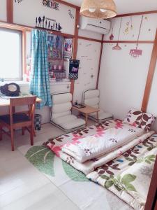 a bedroom with a bed and a table and a desk at Komorebi in Uji