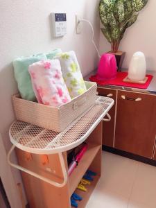 a basket on a shelf in a room at Komorebi in Uji