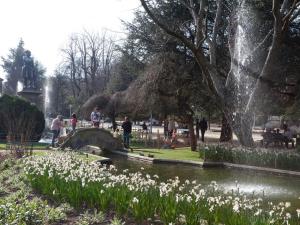 a fountain in a park with a pond and flowers at Rosalía de Castro, 41 - Centro - VUT-CO-01904 in Santiago de Compostela