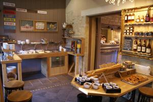 a restaurant with a counter and a table with food at Domaine Utah Beach - Le Grand Hard in Sainte-Marie-du-Mont