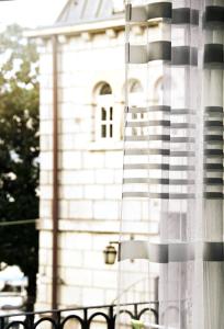 a white building with a window with a flag at Apartments Astoria HN in Herceg-Novi +69 photos