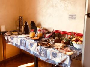 a table with food and drinks on it at B&B del Lago in Sansepolcro