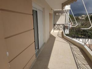 a balcony of a building with a view at Apartment Next to Coast in Nea Anchialos