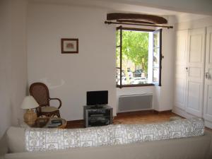 a living room with a couch and a window at Beautiful townhouse in Bargemon in Bargemon