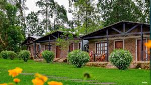 a house with a green lawn in front of it at Hotel Las Azaleas in Jardín América