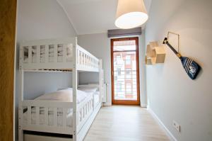 a room with two bunk beds and a door at Grand Apartments - Neptun Park. in Gdańsk