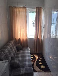 a living room with a couch and a window at Apartments Astoria HN in Herceg-Novi