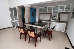 a kitchen with a table and chairs in a room at Chrish Residence in Negombo
