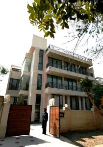 a police officer standing in front of a building at Ahuja Residency Parklane, Gurgaon in Gurgaon