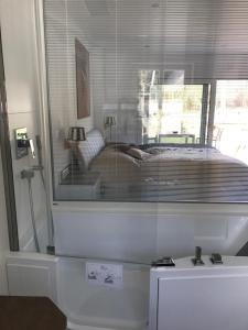 a reflection of a bed in a glass window at Ferienwohnungen direkt am Wasser in Burg