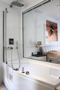 a bathroom with a shower and a large mirror at Ferienwohnungen direkt am Wasser in Burg