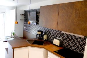 a kitchen with a sink and a counter top at Ferienwohnungen direkt am Wasser in Burg +33 photos