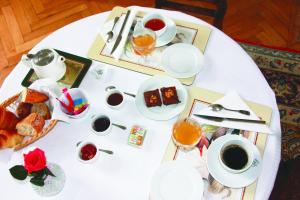 a white table with breakfast foods and coffee on it at Chateau du Gerfaut in Azay-le-Rideau