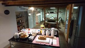 a kitchen with a table with food on it at Relais del Sosto in Olivone