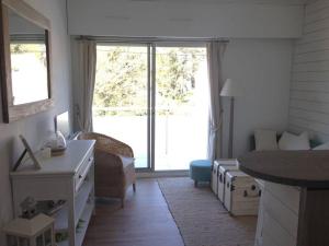 a living room with a large window and a couch at 18 Rue de la Corvette in Saint-Palais-sur-Mer