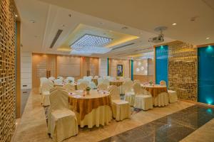 a banquet hall with tables and chairs in a room at Blu Feather Hotel & Spa in Udaipur