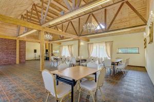 a large room with tables and chairs in it at Spacious Villa with Large Hall in Mindūnai +26 photos