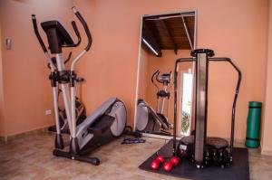 a gym with several exercise bikes and a treadmill at Family-Flexication-Friendly Villa, few steps from Eagle Beach in Palm-Eagle Beach