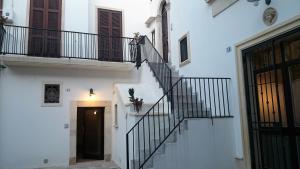a staircase in a white building with a door at Sweet Home Arco Porta Luce in Galatina